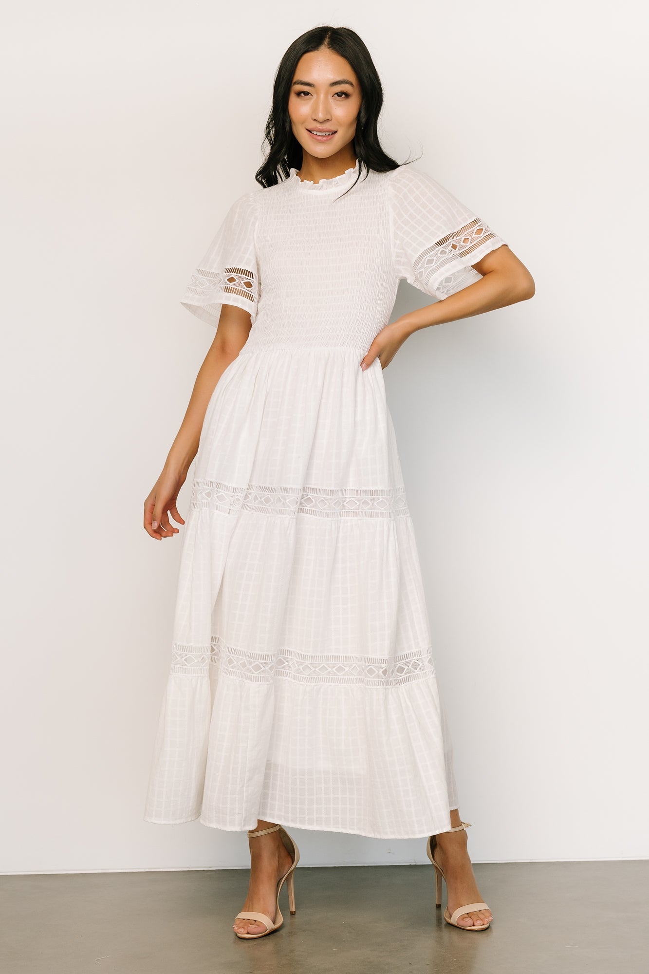 Front view of off-white Loveland Geo Lace Maxi Dress showing ruffled neckline, smocked bodice and tiered skirt.
