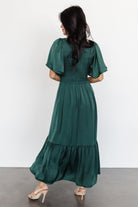 Back and movement view of Lovell Smocked Midi Dress in emerald with smocked bodice and lined mid skirt.