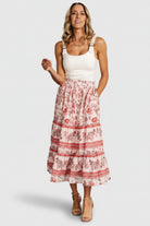 Styled outfit image with Meg blush multi skirt paired with a casual top, illustrating versatile wear from daytime to dressier occasions.