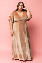 Close-up of champagne velvet texture and seam detailing, showing slight stretch in the pile and the soft drape of the fabric across the bodice.