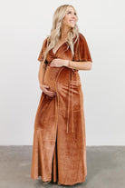 Detail view of the waist tie and V-neck wrap construction on the spice velvet maxi, highlighting the adjustable fit and closure.