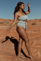Detail shot of Milos bandeau top fabric texture and removable padded cup insert, illustrating quality stretch and finish in sage.
