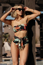 Model wearing Milos high‑waist bikini bottom in Midnight Floral, front view showing fit and moderate coverage on a 5'6" model.