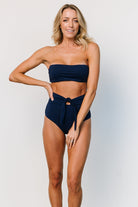Styled image of navy high-waist bikini bottom paired with matching top to demonstrate set coordination and overall fit aesthetic.