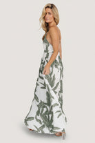 Full-length studio shot of the green floral maxi dress displaying its drape, length and lined silhouette on a model.
