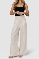 Flat-lay detail of Parvati pants showing fabric weave, natural color, and garment proportions for styling reference.