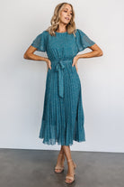Front view of Prim Pleated Midi Dress in Persian blue floral print; chiffon fabric, pleated skirt, removable waist tie, midi length.