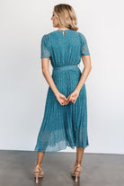 Back view of Prim Pleated Midi Dress featuring button-and-keyhole closure and removable waist tie in Persian blue floral print.