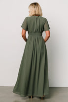 Detail shot of the V-neckline and flutter sleeve on the Ramona Maxi Dress in dark sage, highlighting feminine shaping.