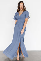 Styled look showing how the whisper-blue chiffon dress pairs with minimal accessories for wedding guest or event wear.