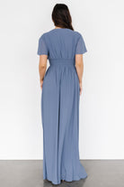 Full-length studio shot of the chiffon maxi on model, showing soft hemline, V-neck and overall elegant silhouette.