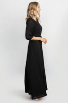 Detail shot of Rebecca Maxi Dress in black focusing on the removable belt tie at the natural waist and soft polyester fabric texture.