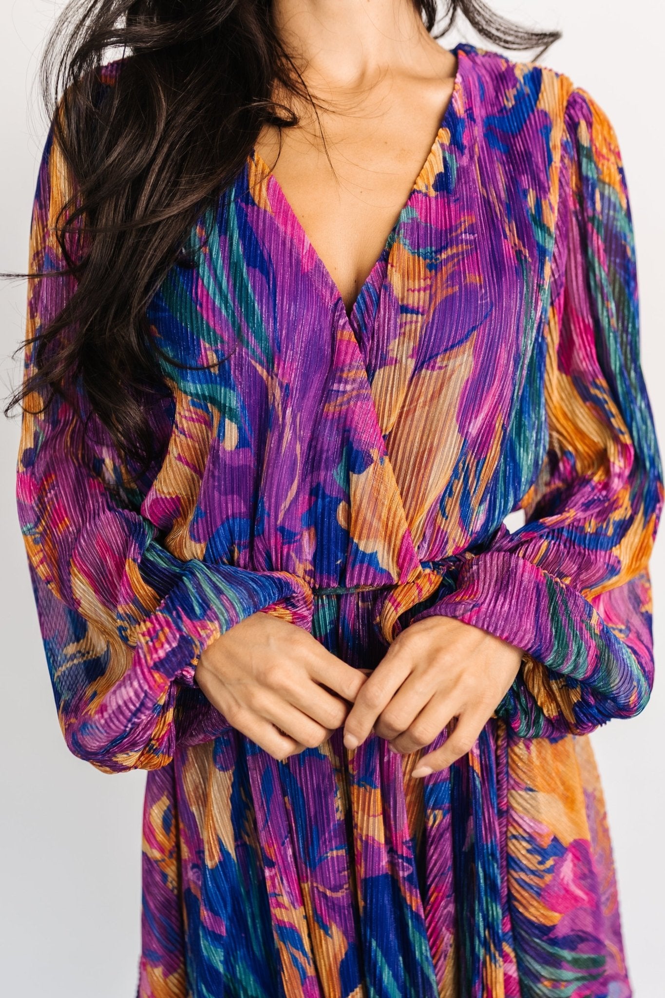 Close-up of the Rev dress bodice in blue multi print highlighting the crossover button neckline and the delicate pleated fabric.