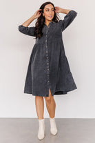 Front view of washed black Sari Babydoll Dress on model, showing button-front, gathered tiers, side pockets, and oversized 3/4 sleeves.