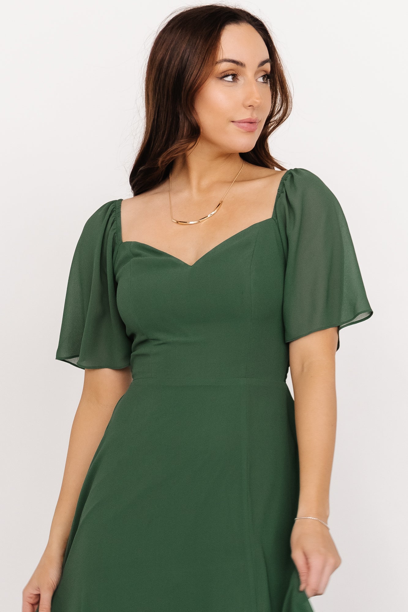 Close-up of bodice on Sierra Sweetheart Maxi Dress in evergreen, emphasizing the sweetheart neckline, smocking detail, and fabric texture.
