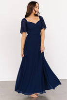 Front view of navy chiffon maxi dress with sweetheart neckline, smocked back bodice and front-left slit, fully lined through the body.