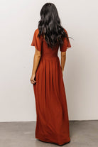 Detail shot of fabric movement and front left slit on Spice maxi dress, showing drape and lightweight polyester chiffon weave