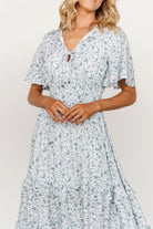 Close-up of bodice showing V-neckline, open seamed bodice, and adjustable bust and neckline ties in white and sage print.