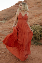 Studio shot of rust lace top maxi dress on mannequin showing tiered silhouette, hemline length, and lined construction.