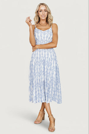 Three-quarter view showing adjustable tank straps, elastic at the back neck and the dress's textured blue-and-off-white rayon blend fabric.