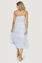 Detail image highlighting the V-neckline, fabric print and the dress's soft texture, showing color contrast between blue and off-white motifs.