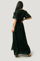 Detail shot of the elastic waistband and detached self-tie sash on the dark green Uma Maxi, showing stitching and fabric drape.