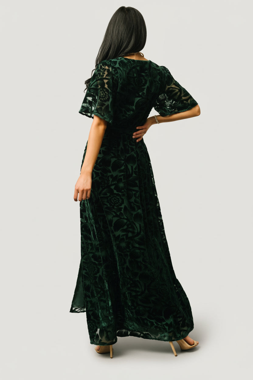 Detail shot of the elastic waistband and detached self-tie sash on the dark green Uma Maxi, showing stitching and fabric drape.